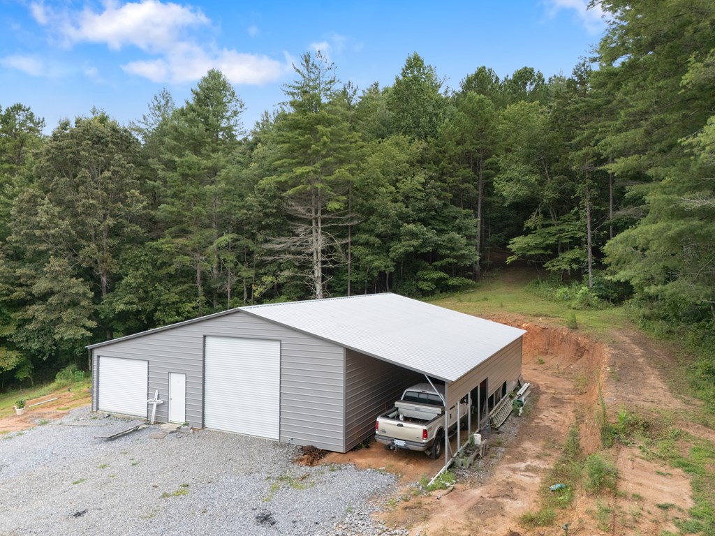 115 Ash Loop Road Hayesville, NC 28904 - Photo 8 of 37 a view of a white house with a yard and outdoor seating