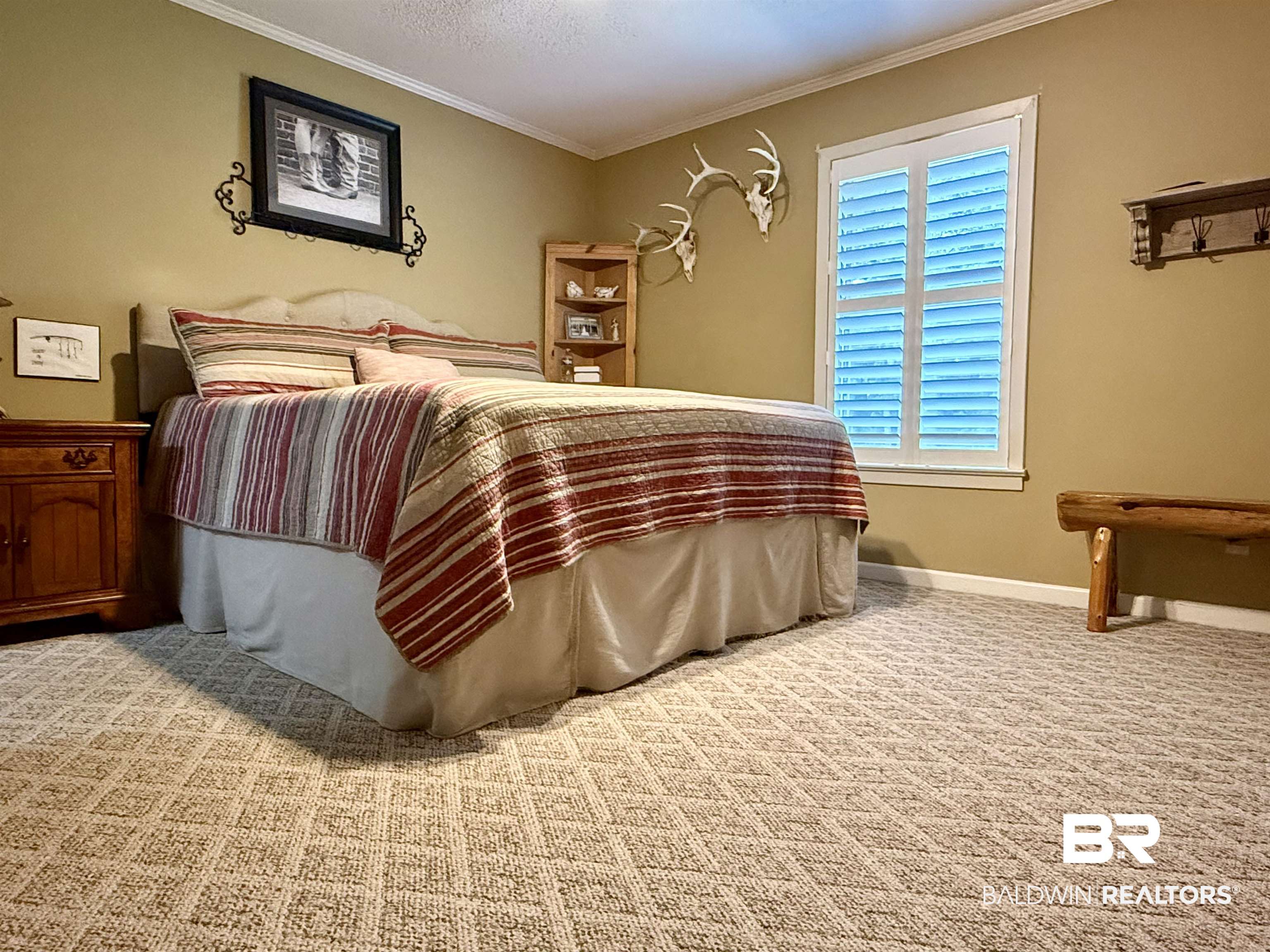 5971 Appleton Road Brewton, AL 36426 - Photo 12 of 23 Carpeted bedroom with crown molding and baseboards