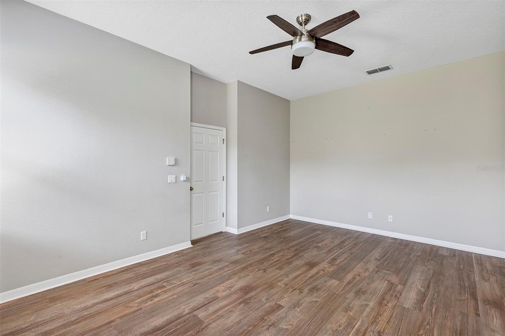 1816 Cherry Ridge Drive Lake Mary, FL 32746 - Photo 19 of 64 an empty room with wooden floor and a ceiling fan