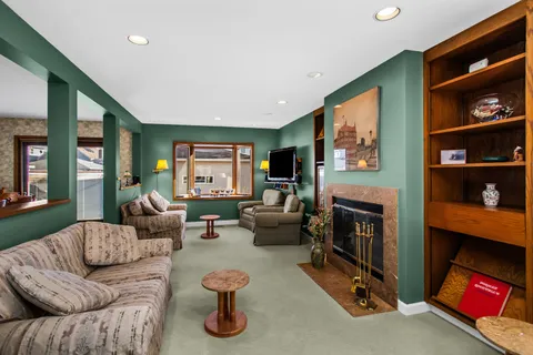 a living room with furniture and a fireplace
