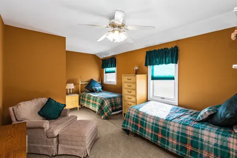 a bedroom with a bed couch and window