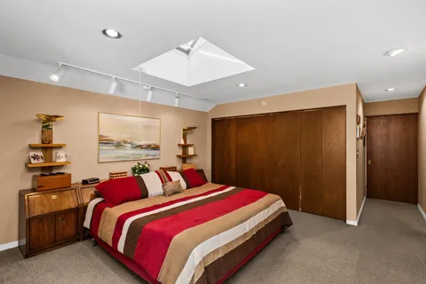 a bedroom with a bed and a chandelier