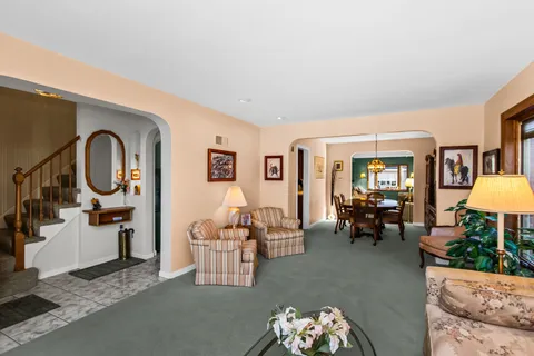 a living room with furniture and a chandelier