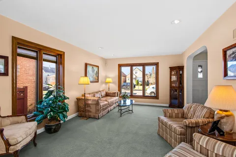 a bedroom with furniture and a large window