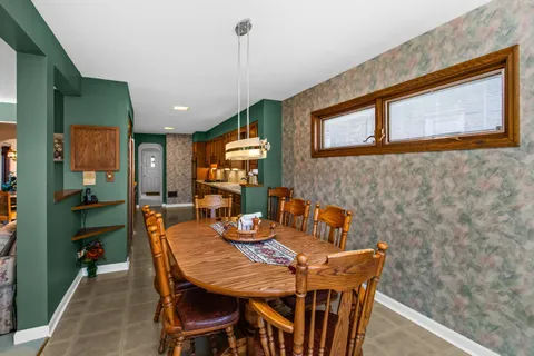 a dining room with furniture and window