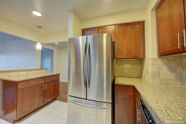 a kitchen with a refrigerator and a sink