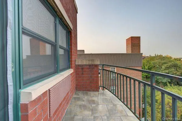 a view of a balcony with furniture