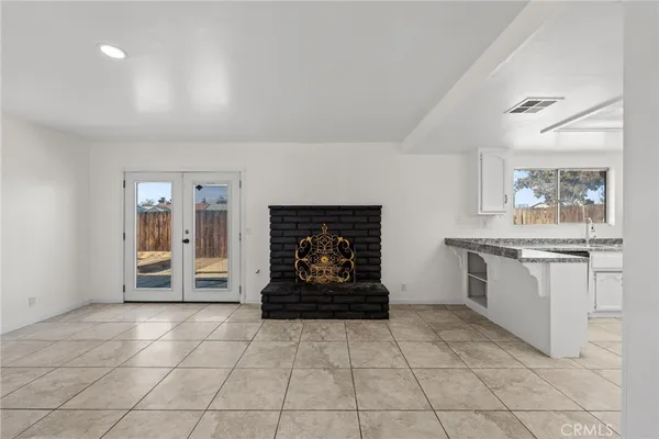 a view of a livingroom with wooden floor and a sink