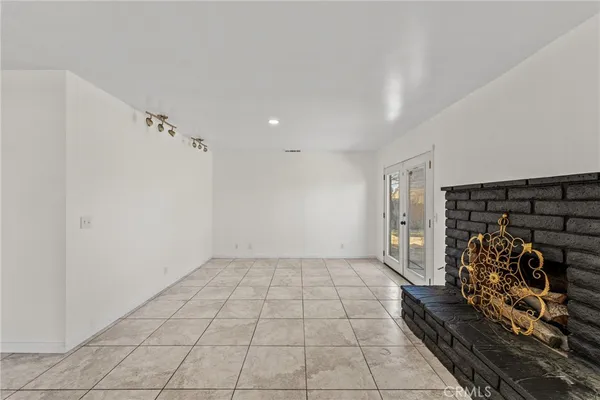 a kitchen with white cabinets and appliances