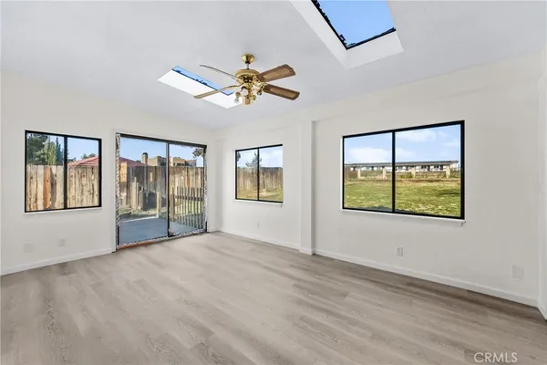 a view of an empty room and wooden floor