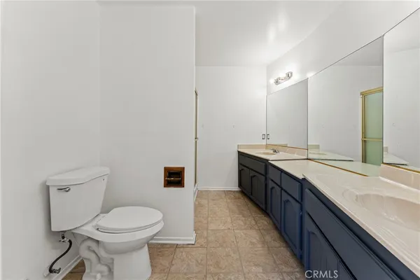a bathroom with a granite countertop sink a mirror and a shower