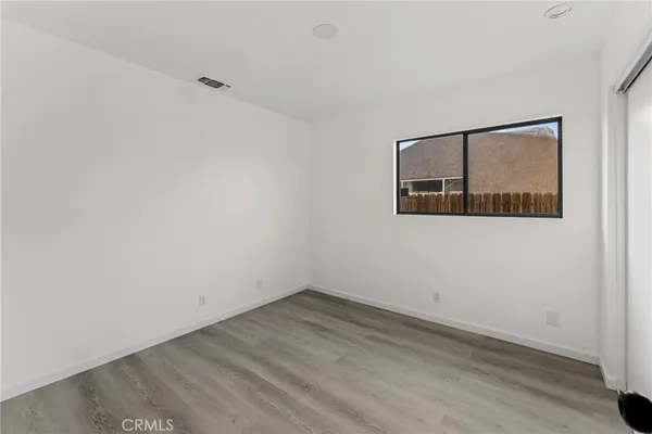 an empty room with wooden floor