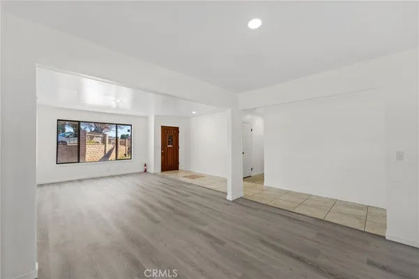 a large white kitchen with cabinets and outdoor space