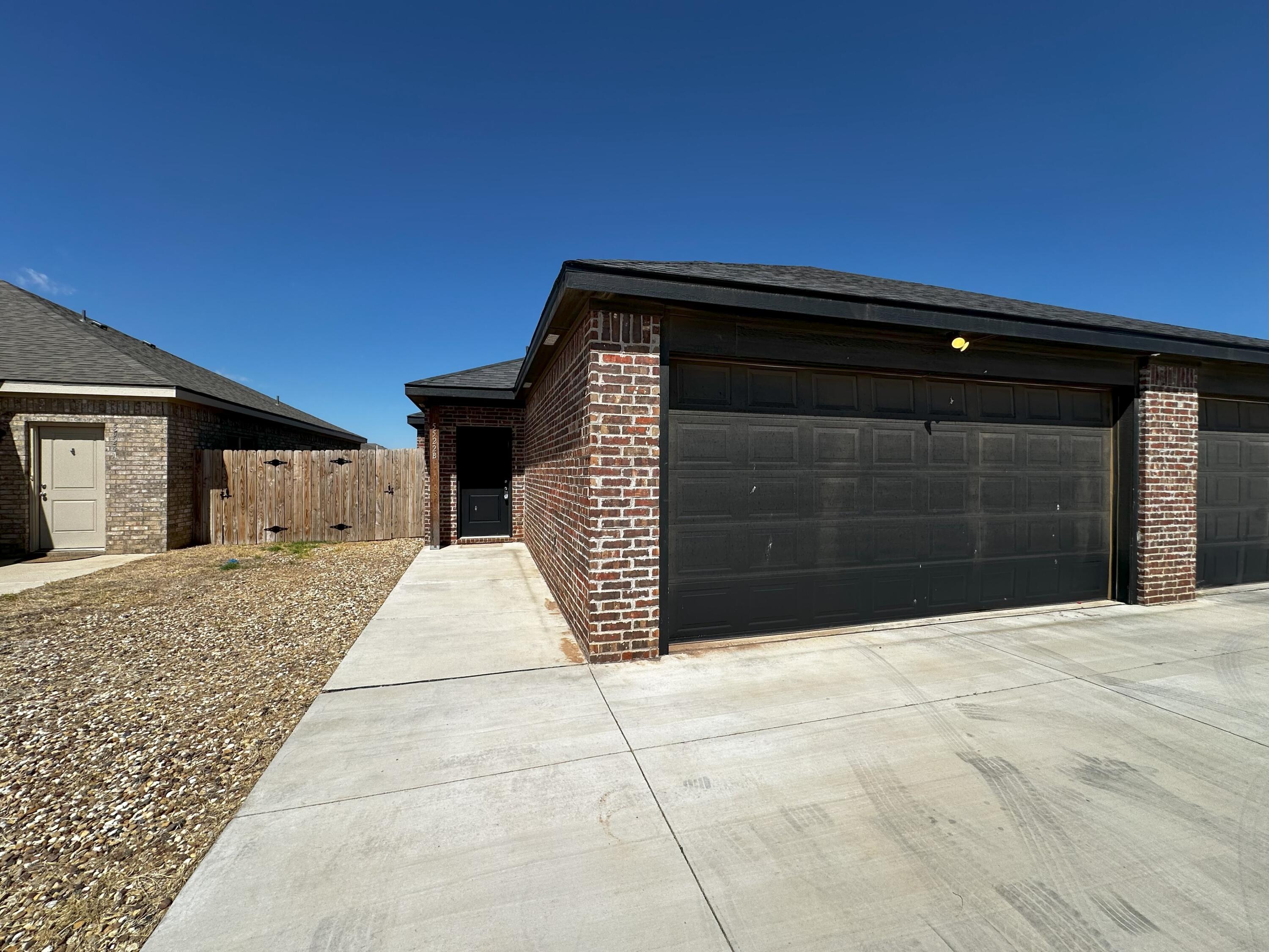 5522 Itasca Street, Unit B Lubbock, TX 79416 - Photo 1 of 1 a front view of a house with a yard