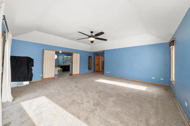 a view of a livingroom with a ceiling fan and window