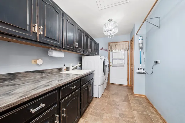 a kitchen with stainless steel appliances granite countertop a refrigerator a sink dishwasher a stove and a refrigerator with wooden floor