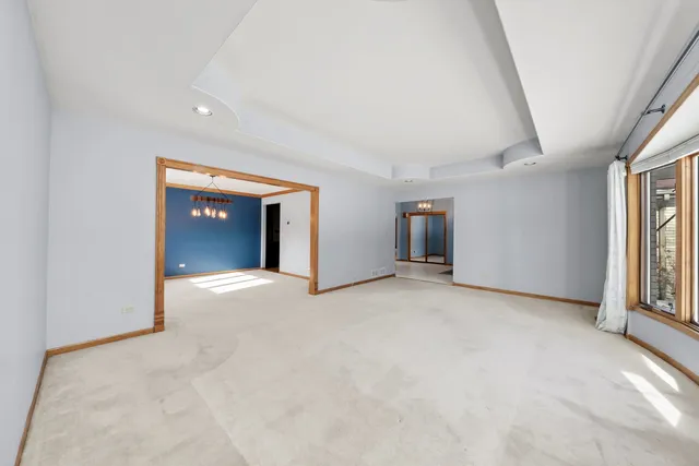 an empty room with windows and cabinet