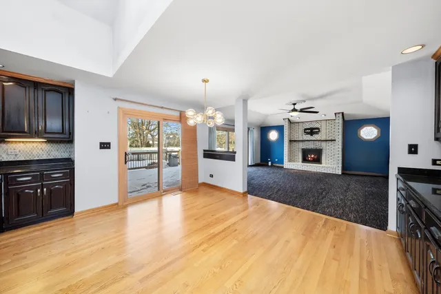 a large kitchen with stainless steel appliances granite countertop a large stove top oven a sink dishwasher and a refrigerator with wooden floor