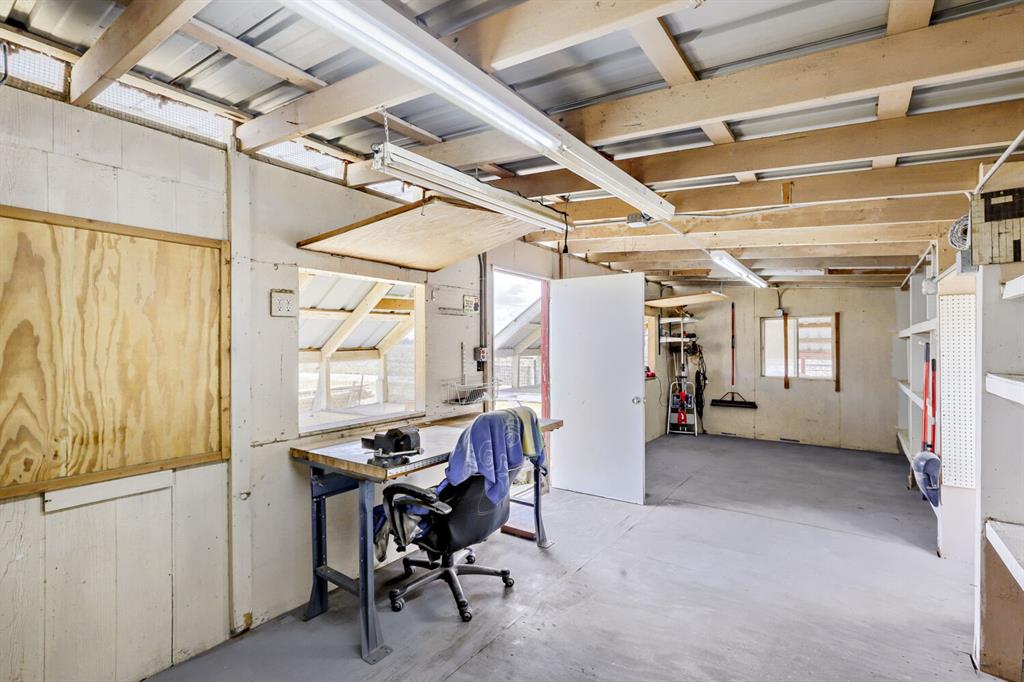 626 Epps Road Palmer, TX 75152 - Photo 32 of 40 Workshop space featuring exposed wood beam ceiling, concrete flooring, built-in shelving, and multiple windows providing natural light