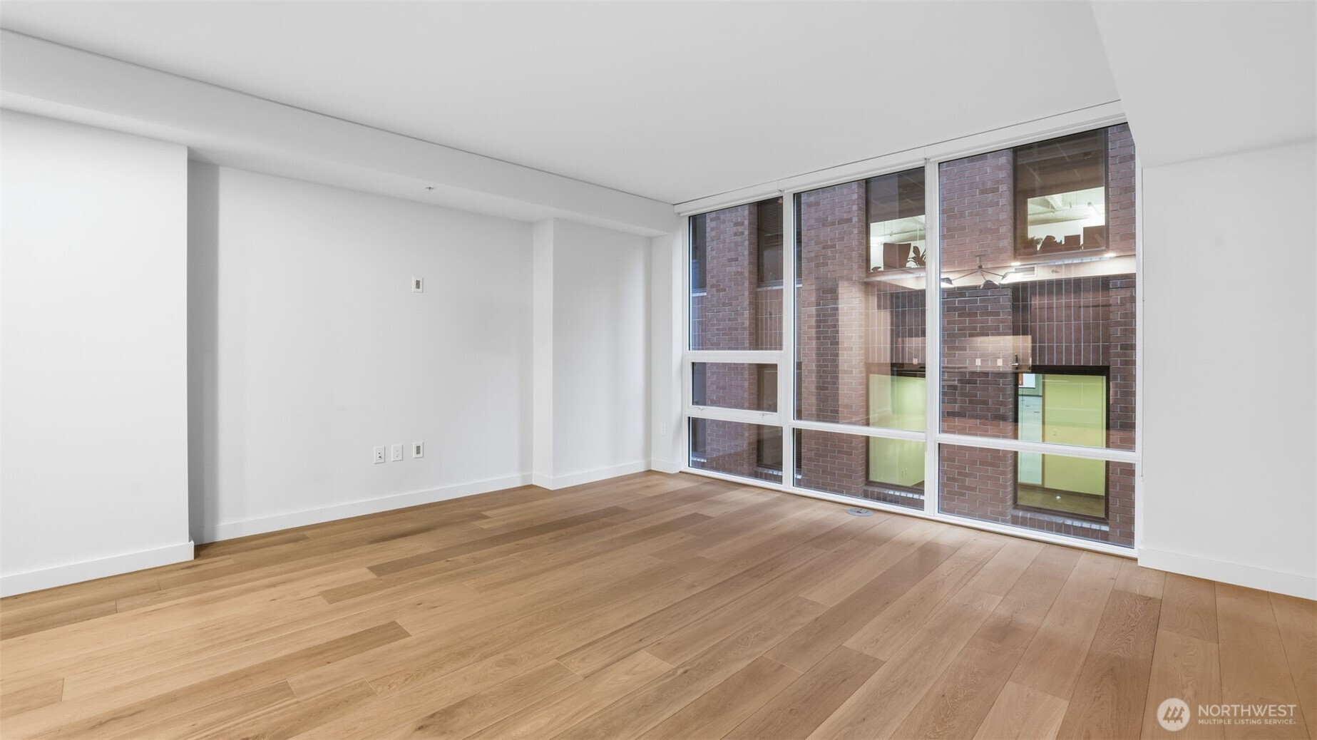121 Stewart Street, Unit 905 Seattle, WA 98101 - Photo 11 of 37 a view of empty room with wooden floor and fan