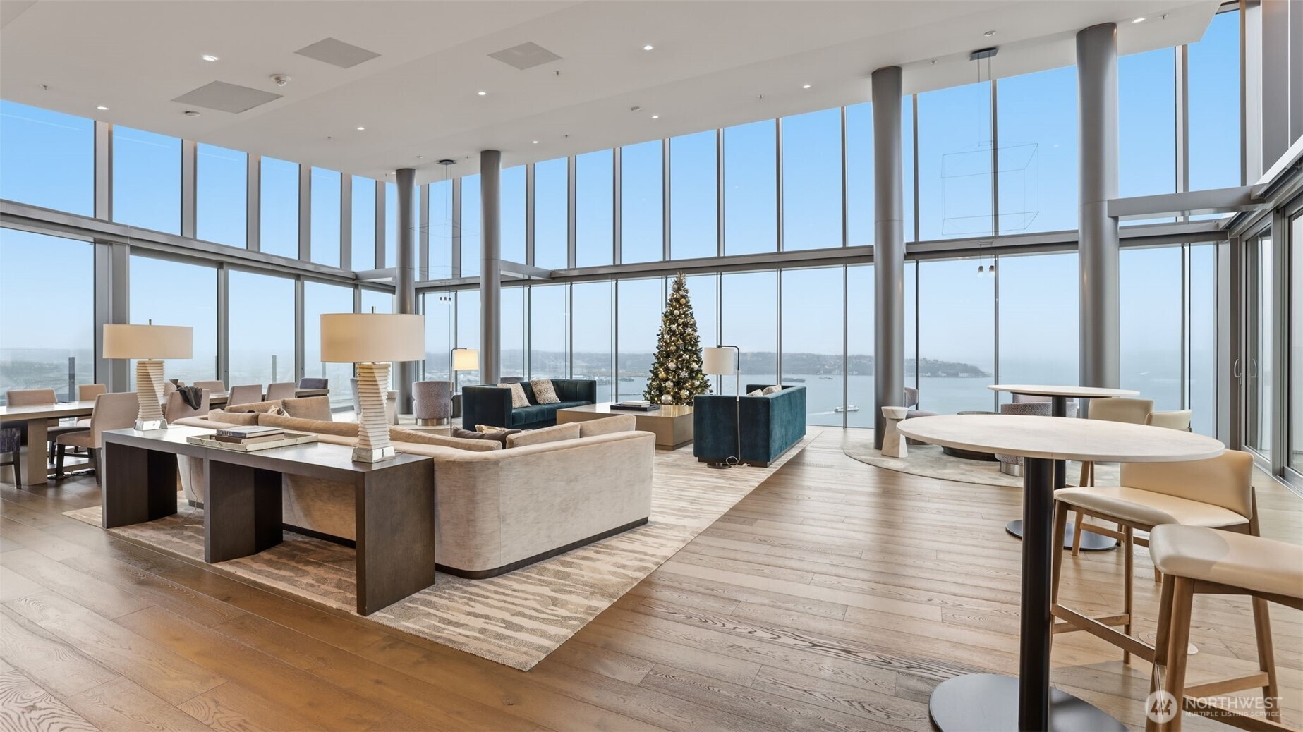 121 Stewart Street, Unit 905 Seattle, WA 98101 - Photo 19 of 37 a view of kitchen with stainless steel appliances wooden floor dining table and chairs