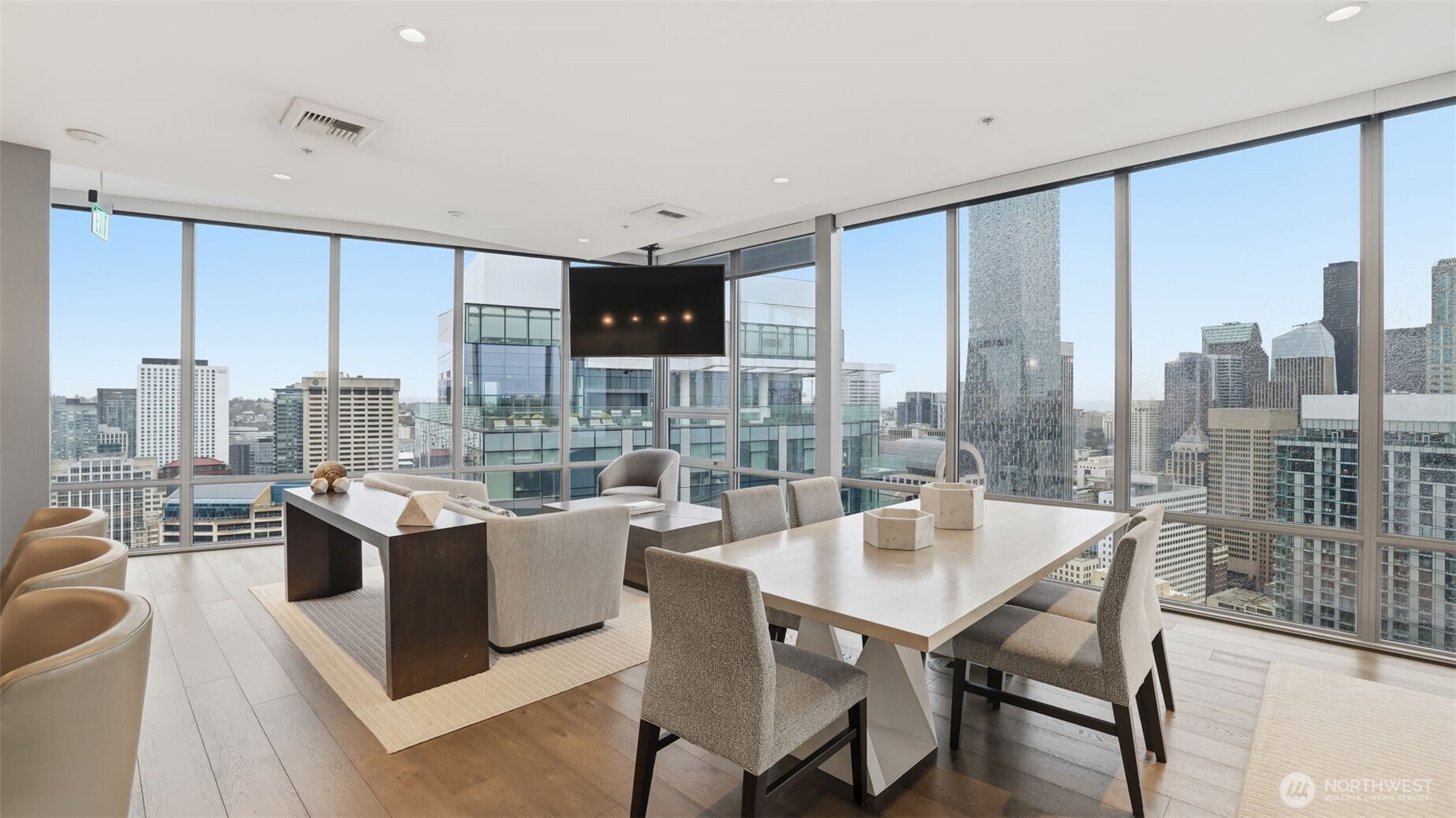 121 Stewart Street, Unit 905 Seattle, WA 98101 - Photo 22 of 37 a dining room with furniture a large window and a chandelier
