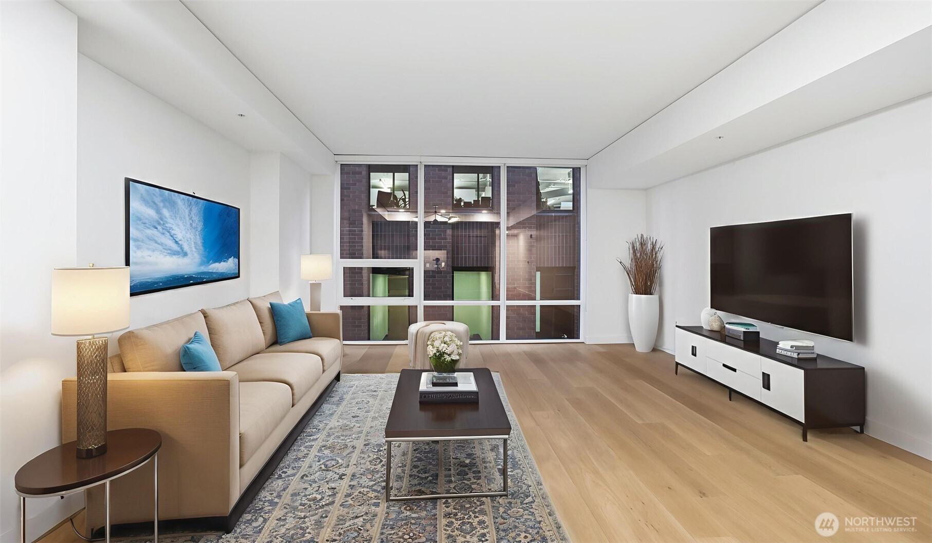 121 Stewart Street, Unit 905 Seattle, WA 98101 - Photo 33 of 37 a living room with furniture and a flat screen tv