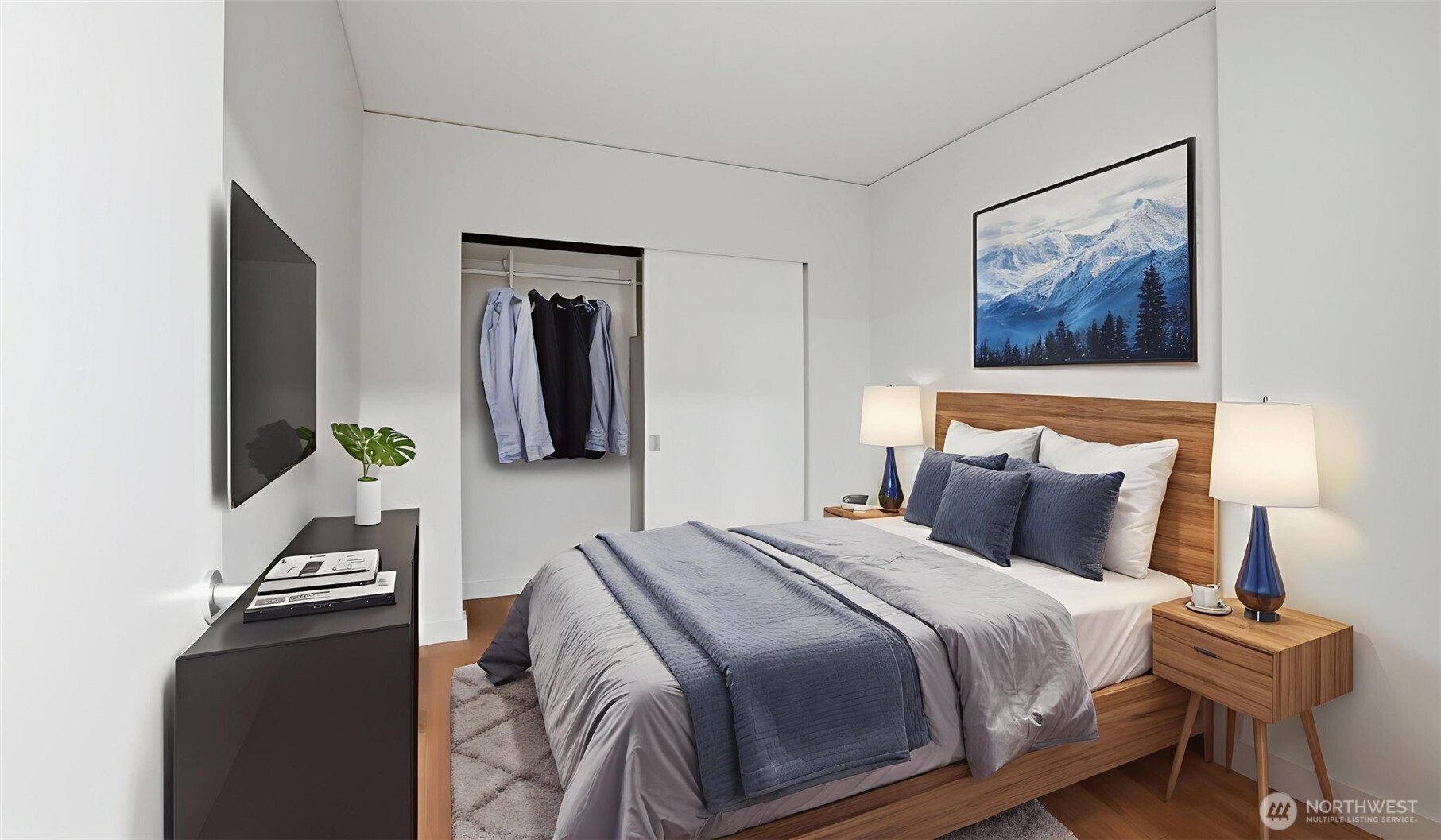 121 Stewart Street, Unit 905 Seattle, WA 98101 - Photo 36 of 37 a bedroom with a bed and a lamp on dresser