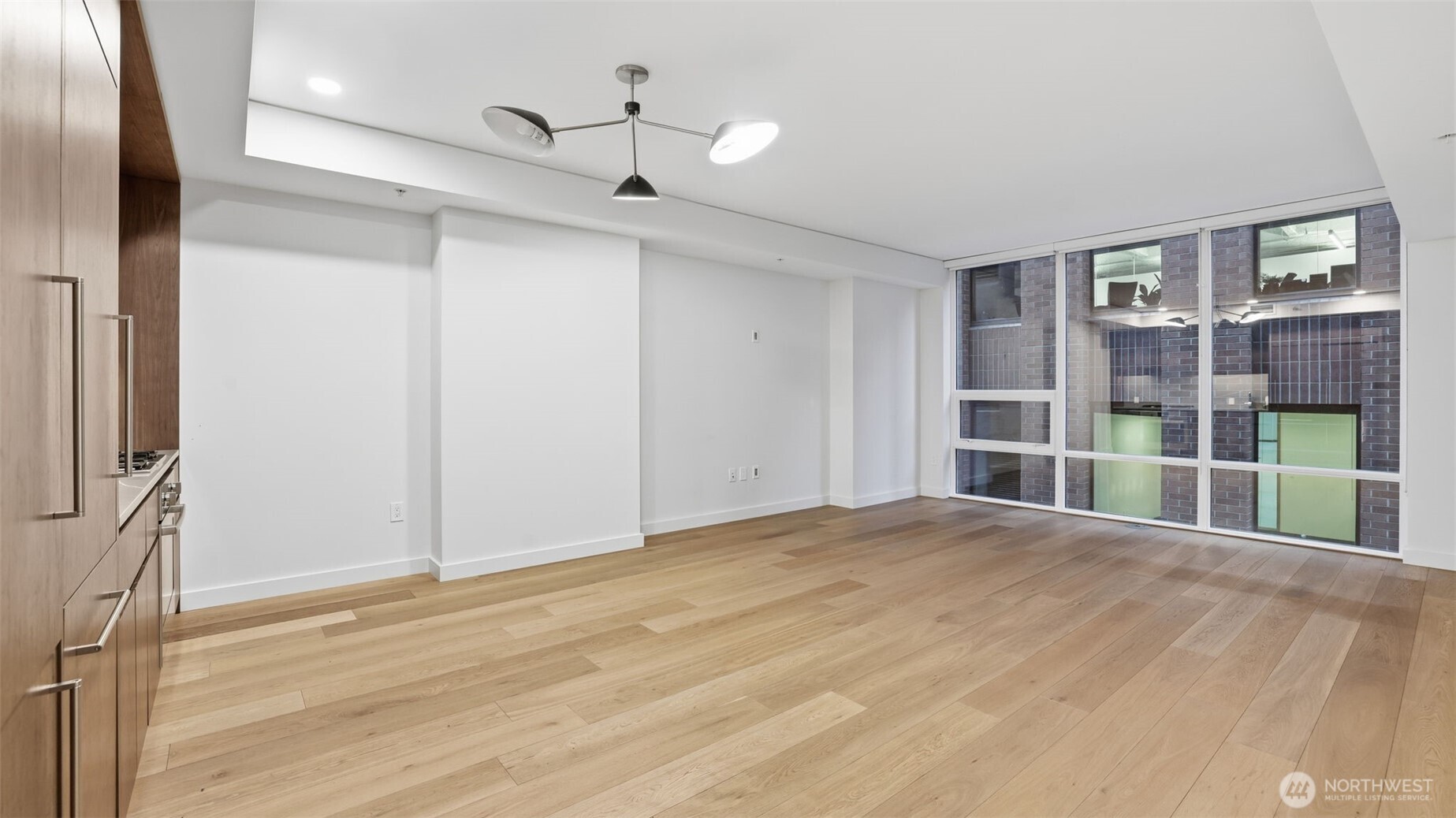 121 Stewart Street, Unit 905 Seattle, WA 98101 - Photo 5 of 37 a view of empty room with wooden floor and fan