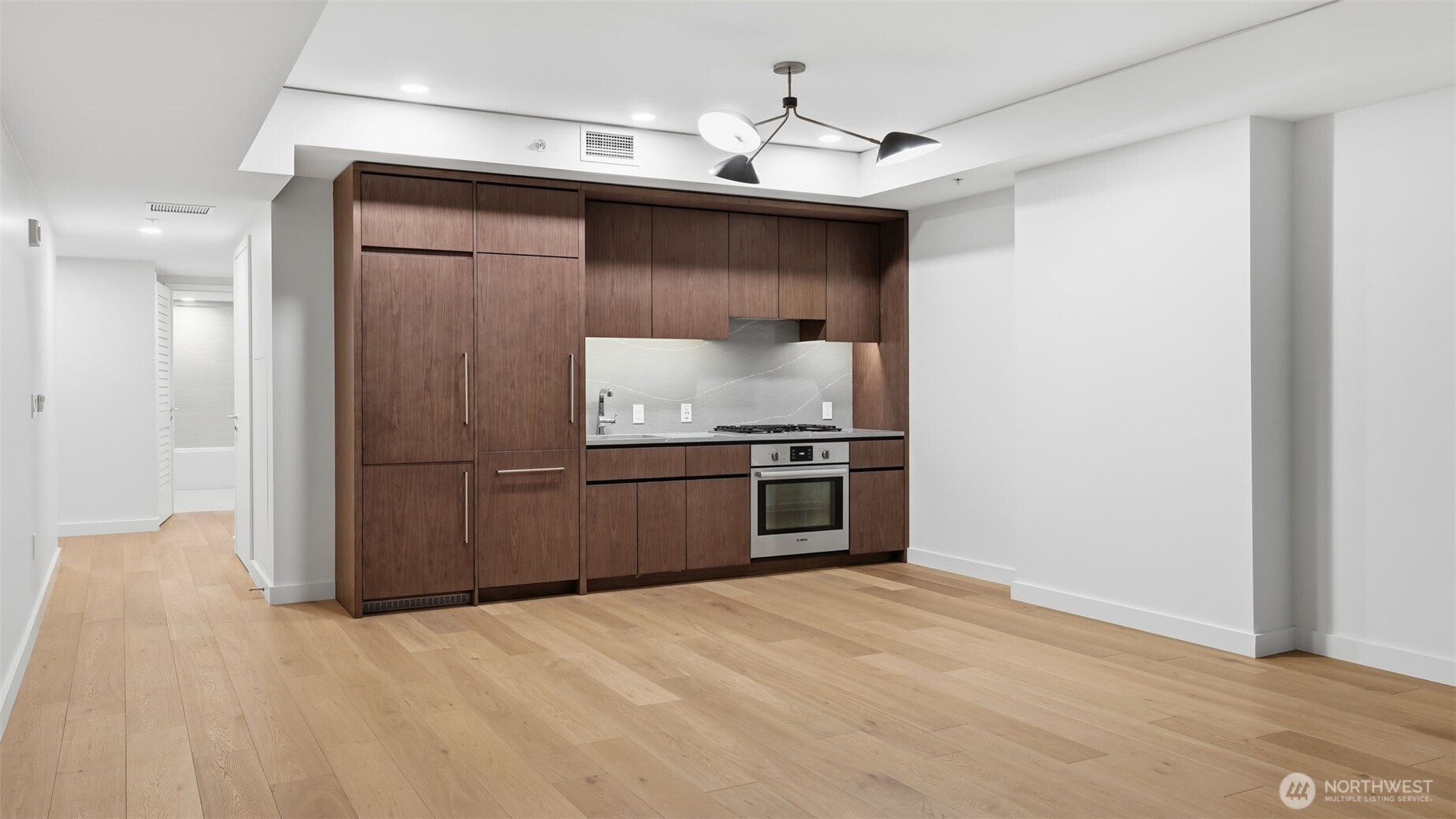 121 Stewart Street, Unit 905 Seattle, WA 98101 - Photo 8 of 37 a kitchen with stainless steel appliances a sink and a refrigerator