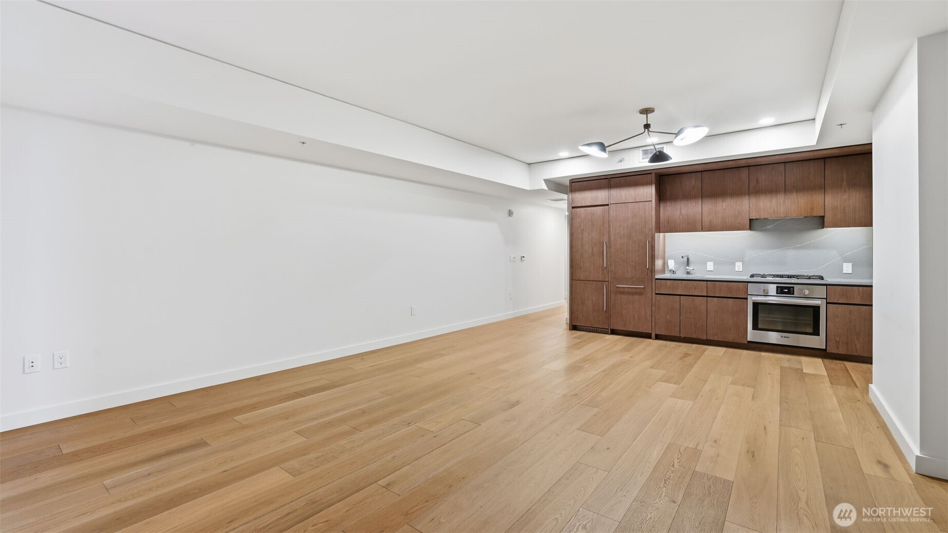 121 Stewart Street, Unit 905 Seattle, WA 98101 - Photo 10 of 37 a view of a kitchen with a stove top oven