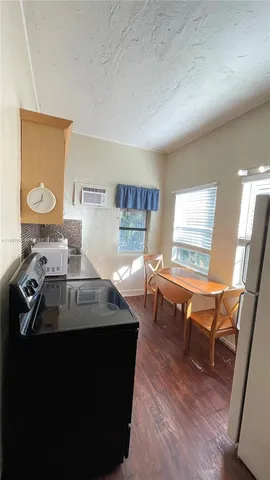 a bathroom with a granite countertop toilet a sink and a large mirror