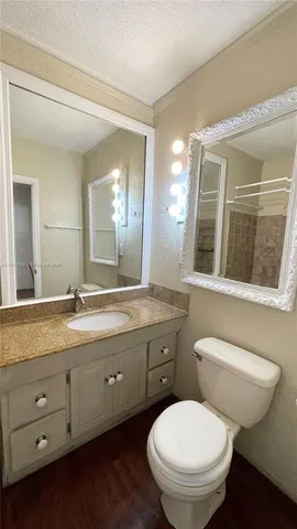 a view of empty room with window and wooden floor