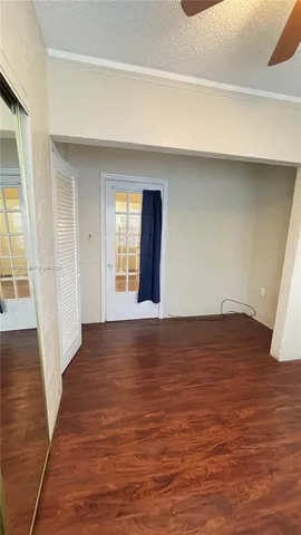 a view of an empty room and wooden floor