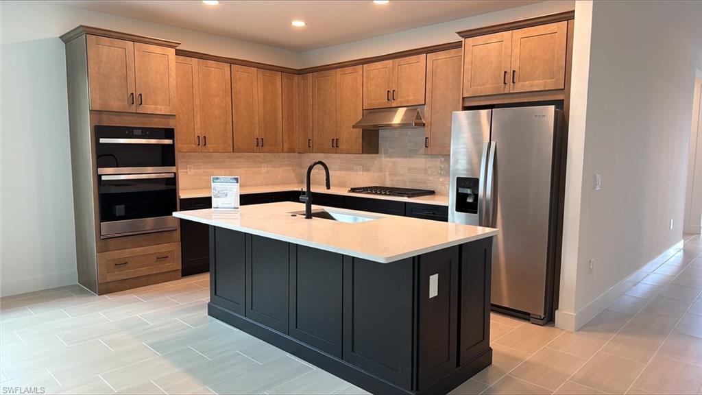 8775 Oceana Way Naples, FL 34114 - Photo 1 of 30 a kitchen with a sink a refrigerator and cabinets