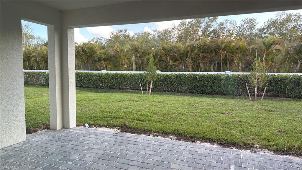 8775 Oceana Way Naples, FL 34114 - Photo 10 of 30 a view of a garden with a large tree