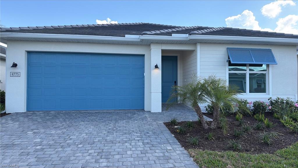 8775 Oceana Way Naples, FL 34114 - Photo 11 of 30 a view of a house with a yard and plants