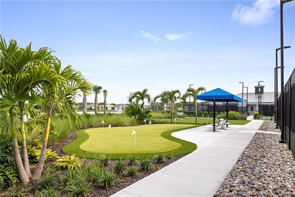 8775 Oceana Way Naples, FL 34114 - Photo 27 of 30 a swimming pool with outdoor seating and yard