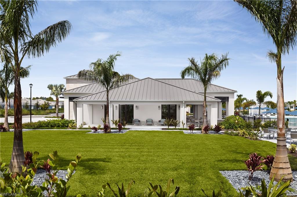 8775 Oceana Way Naples, FL 34114 - Photo 28 of 30 a front view of house with yard and outdoor seating