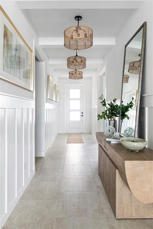 8775 Oceana Way Naples, FL 34114 - Photo 6 of 30 a hallway with mirror and window