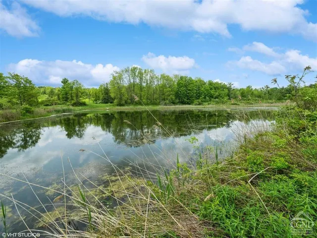 a view of a lake with a house in the background