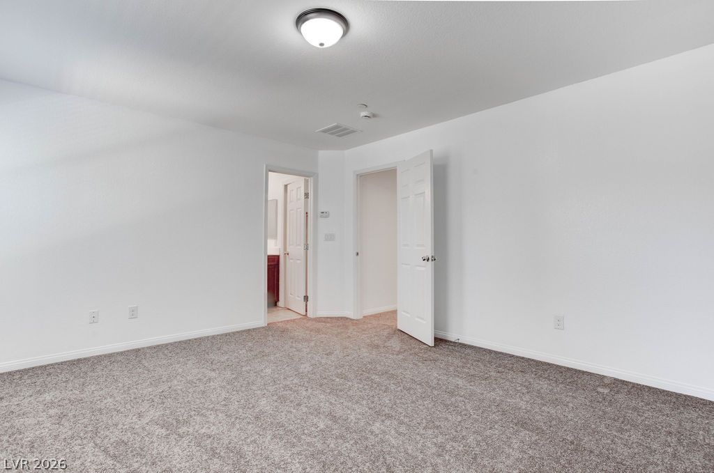 4650 Ranch House Road, Unit 47 North Las Vegas, NV 89031 - Photo 26 of 43 A spacious, naturally illuminated room features plush carpeting and crisp white walls, awaiting personal touches.