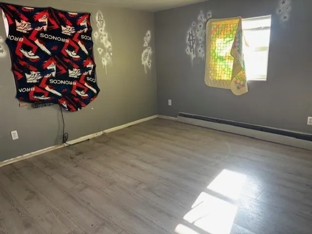 wooden floor in an empty room with a window