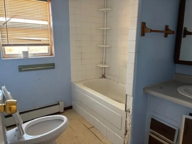 a bathroom with a sink a toilet and bathtub