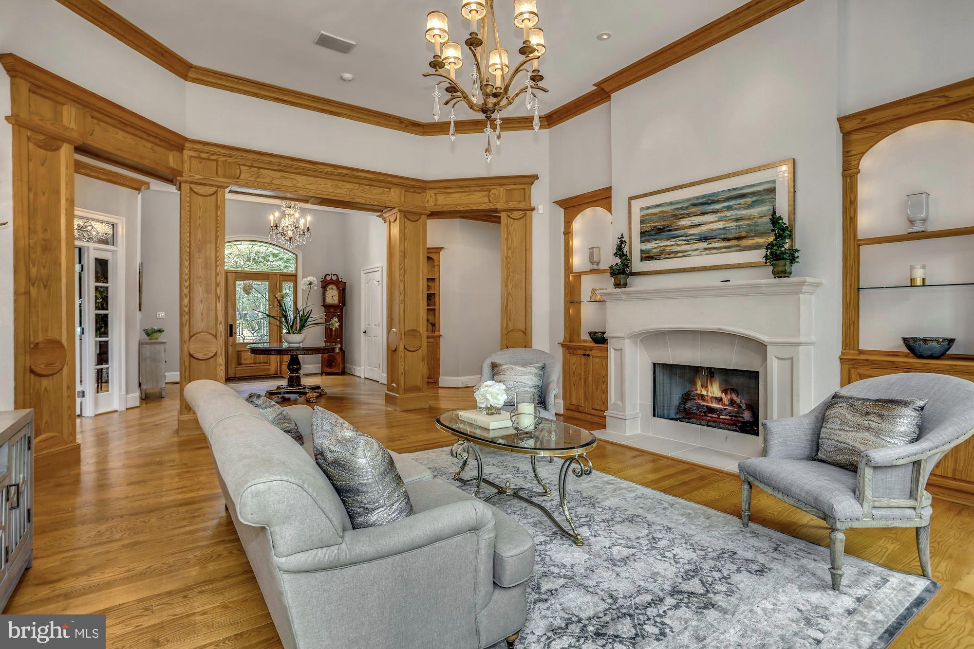 337 Springvale Road Great Falls, VA 22066 - Photo 18 of 120 a living room with furniture a chandelier and a fireplace