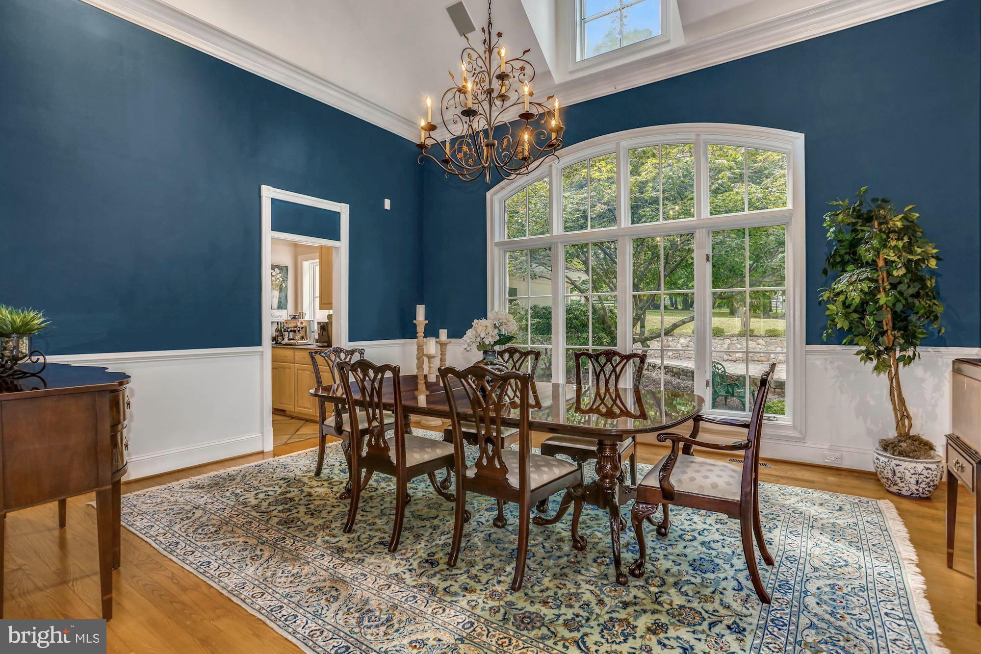 337 Springvale Road Great Falls, VA 22066 - Photo 20 of 120 a dining room with furniture a rug and a chandelier