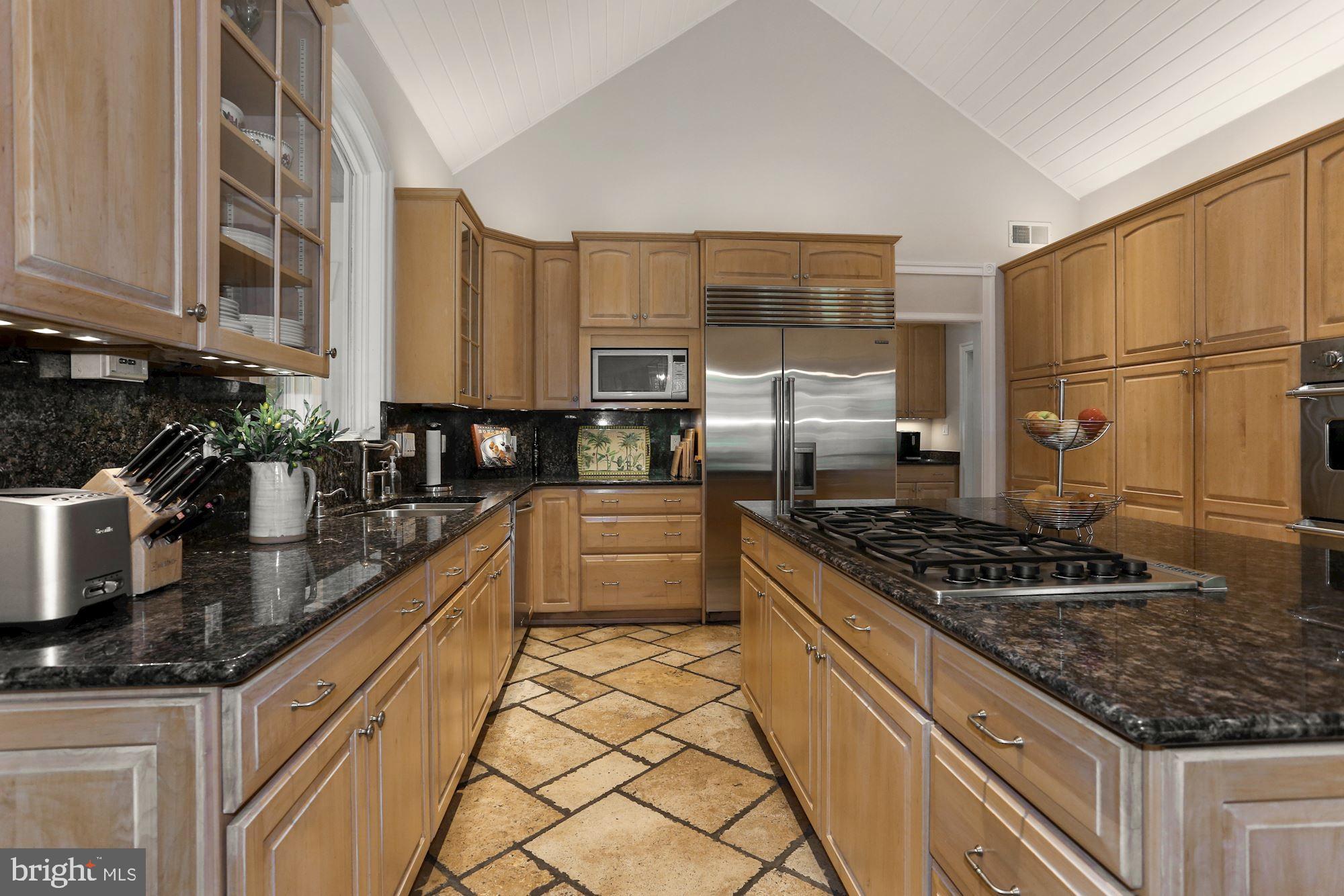 337 Springvale Road Great Falls, VA 22066 - Photo 25 of 120 a kitchen with stainless steel appliances granite countertop a stove a sink dishwasher and a refrigerator