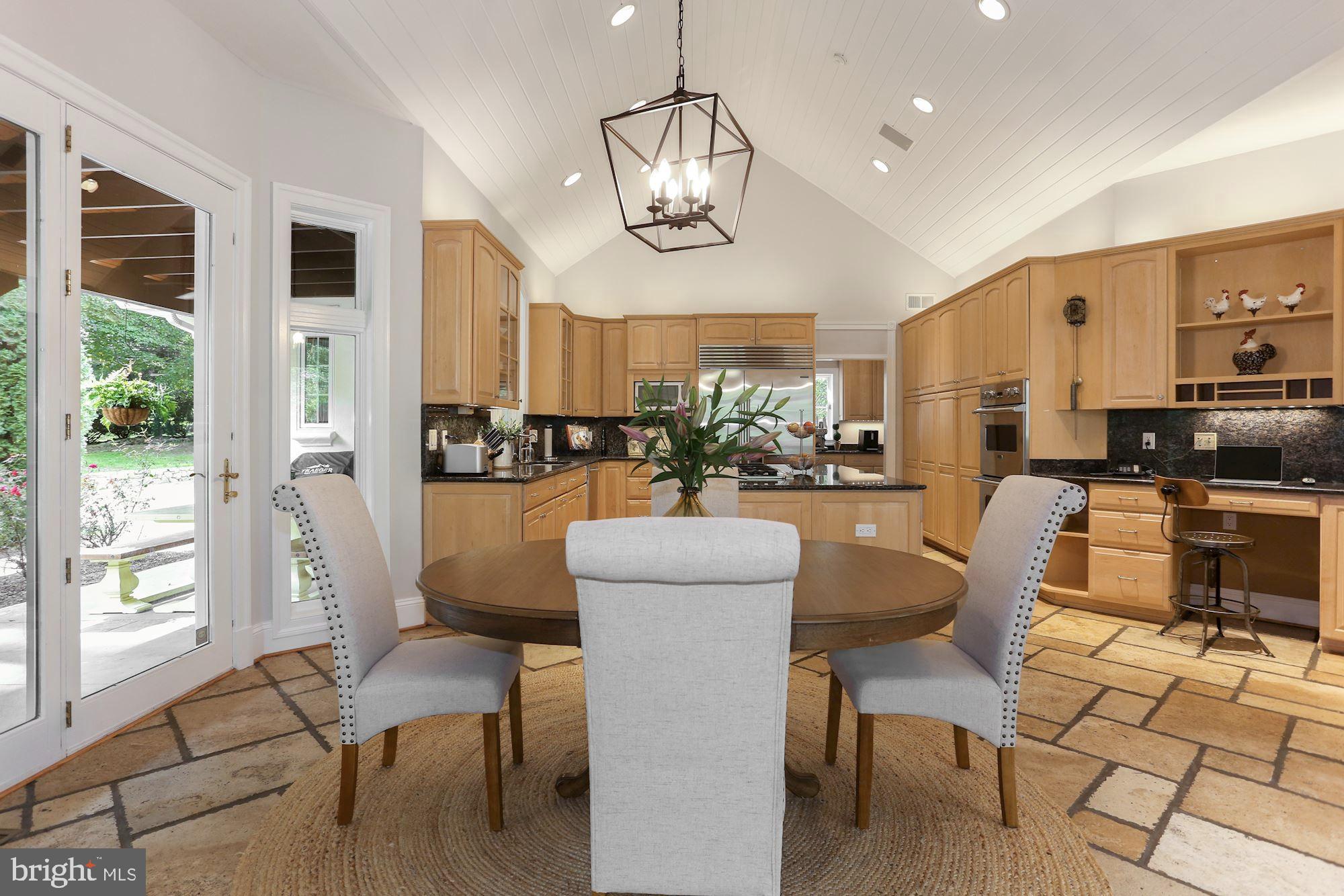 337 Springvale Road Great Falls, VA 22066 - Photo 28 of 120 a dining room with furniture a chandelier and wooden floor