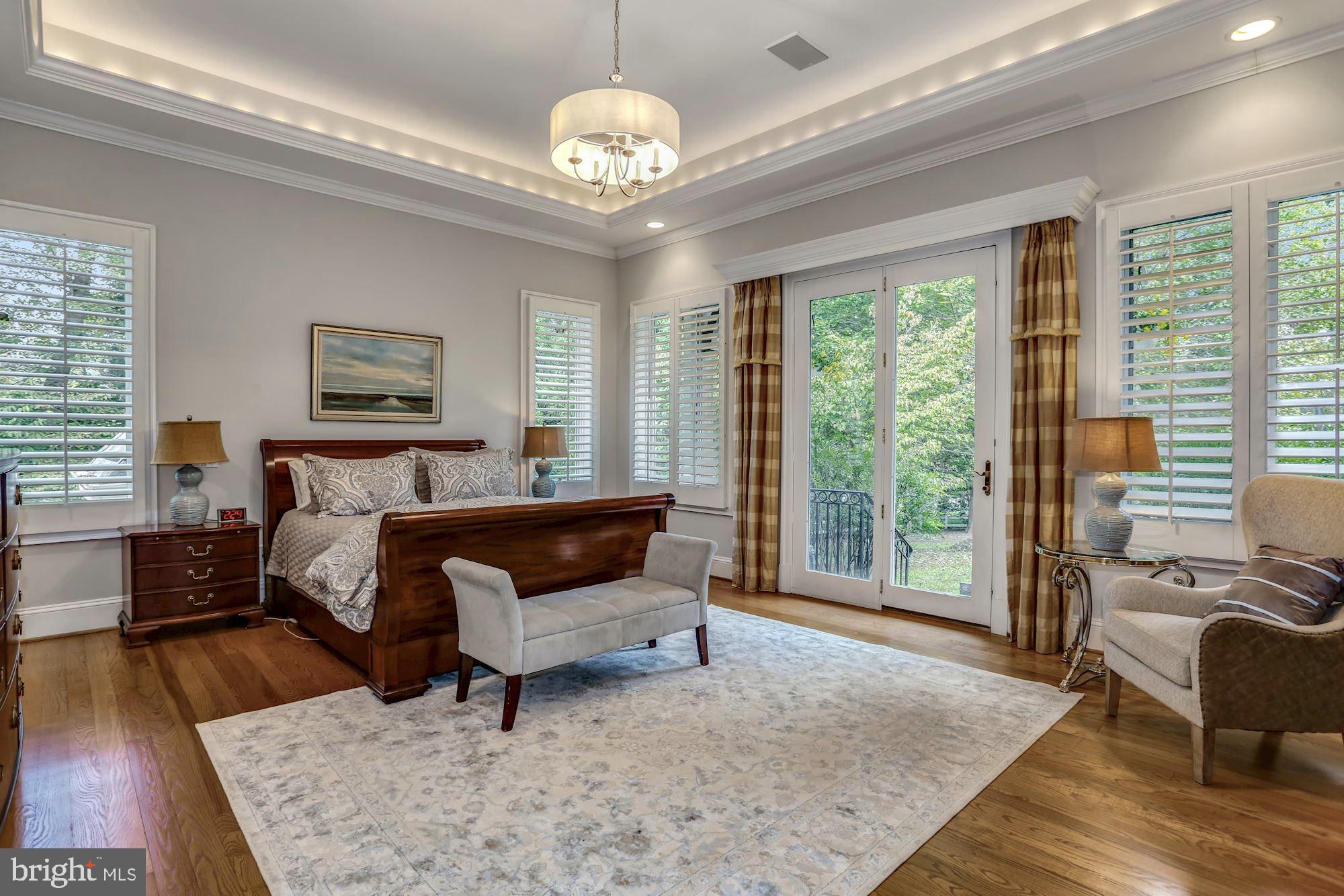337 Springvale Road Great Falls, VA 22066 - Photo 39 of 120 a spacious bedroom with a bed a couch and large window