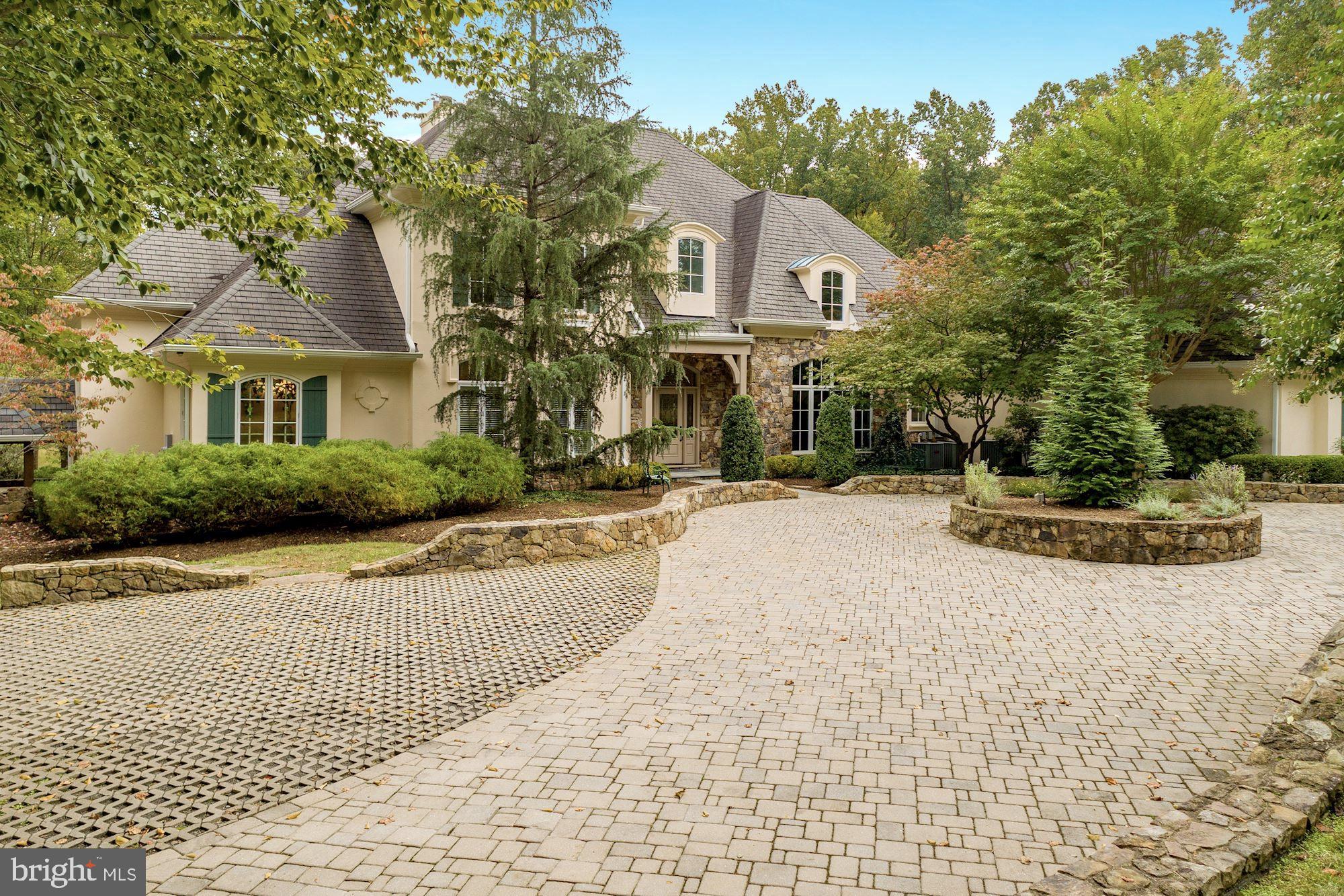 337 Springvale Road Great Falls, VA 22066 - Photo 10 of 120 a front view of a house with a yard and garage